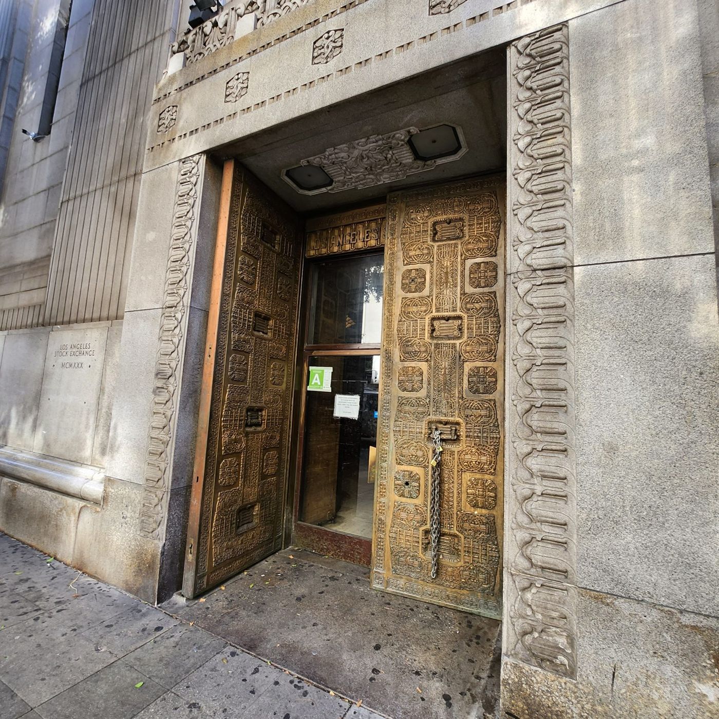 The carved stone portal and bronze doors of the main entrance