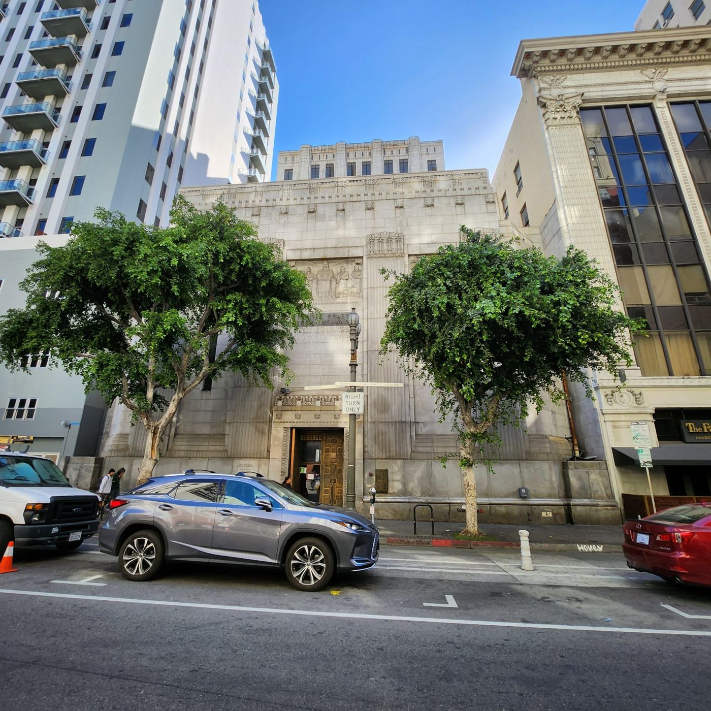 The stone facade of the building on Spring Street